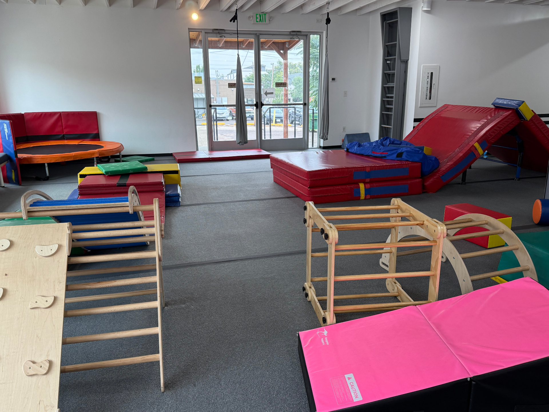 Bright indoor children's play space at tumble HAUS in Denver with foam climbers, tumble mats and sensory toys