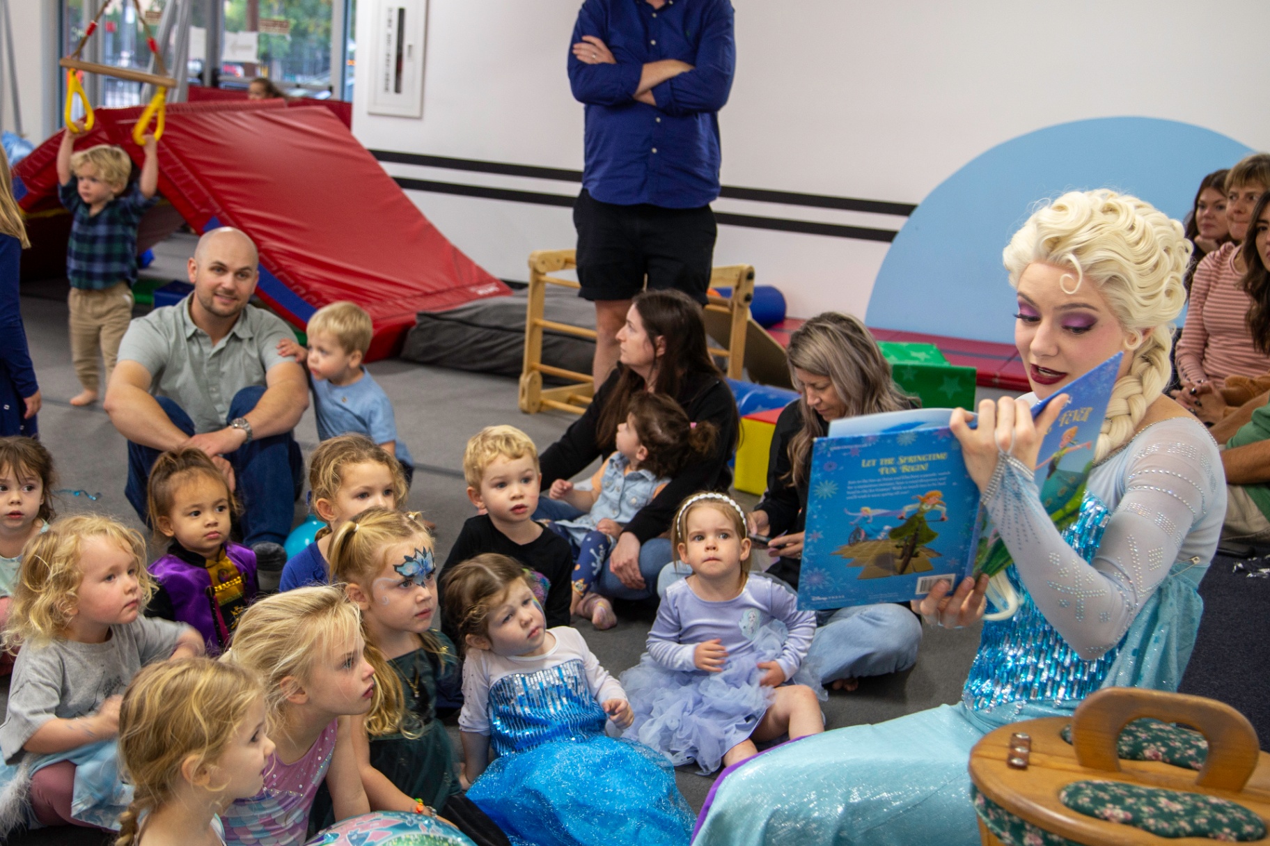 The Ice Queen reading a story to toddlers at a special event at tumble HAUS Denver